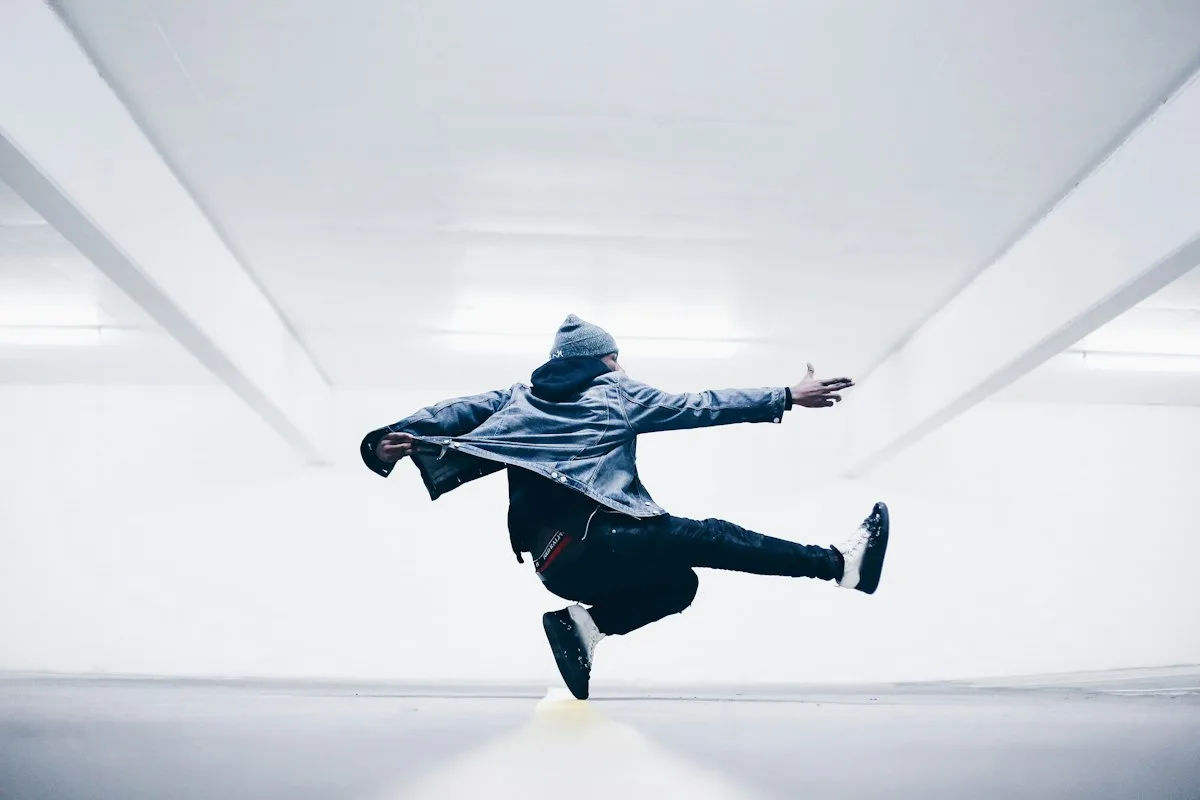 Breakdancer holding a freeze on one hand