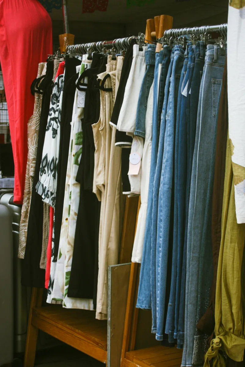 Different types of pants hanging on a clothing rack