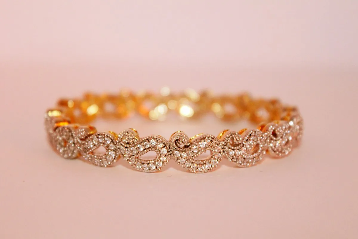Gold bangle bracelet with stones