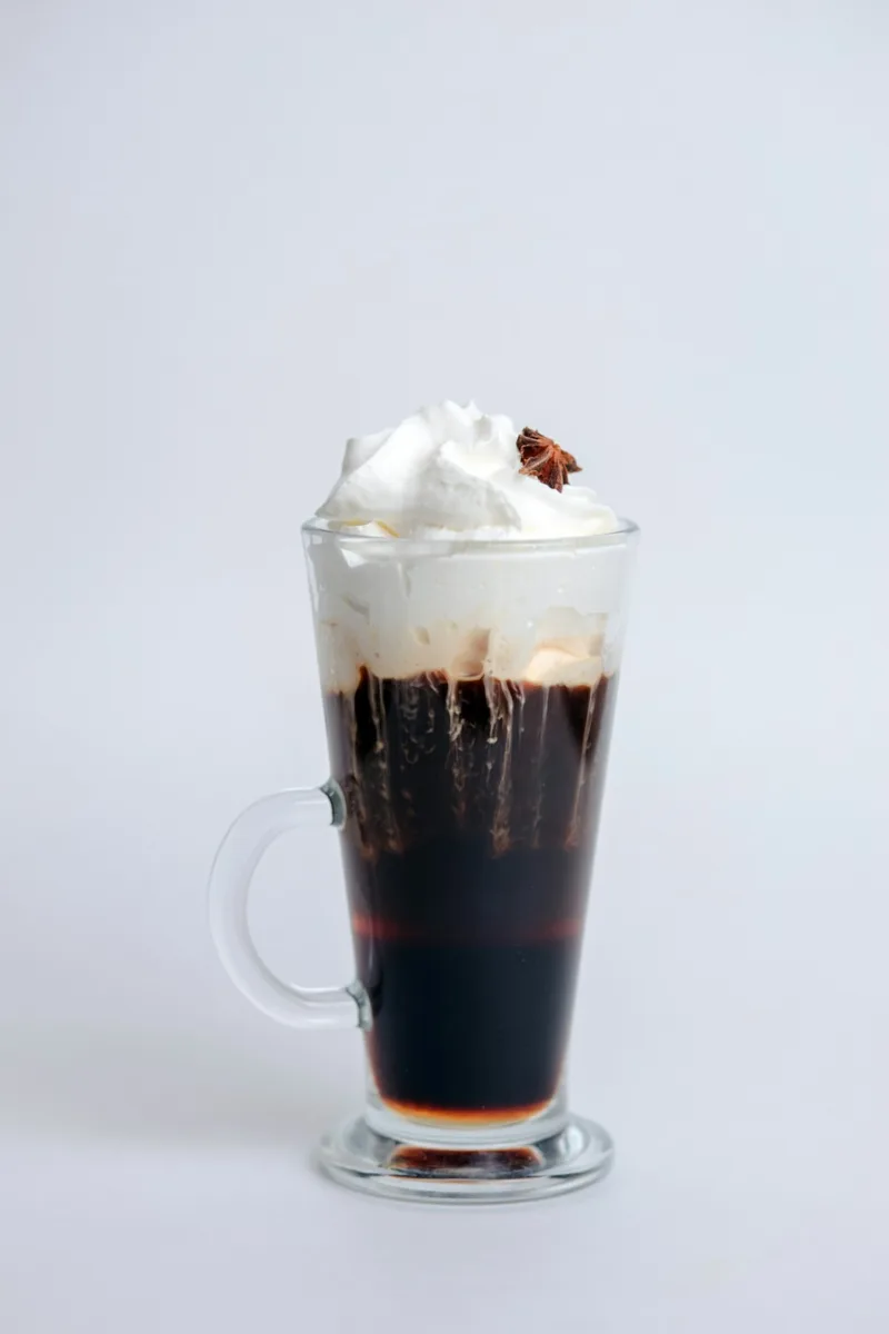 Irish coffee with whipped cream in a glass