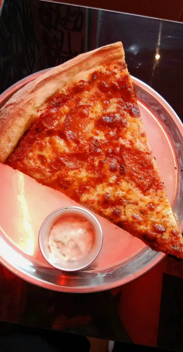 Large slice of New York style pizza