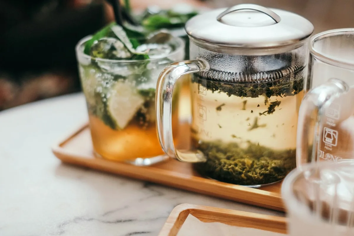 Mint tea in a glass teapot with fresh mint leaves