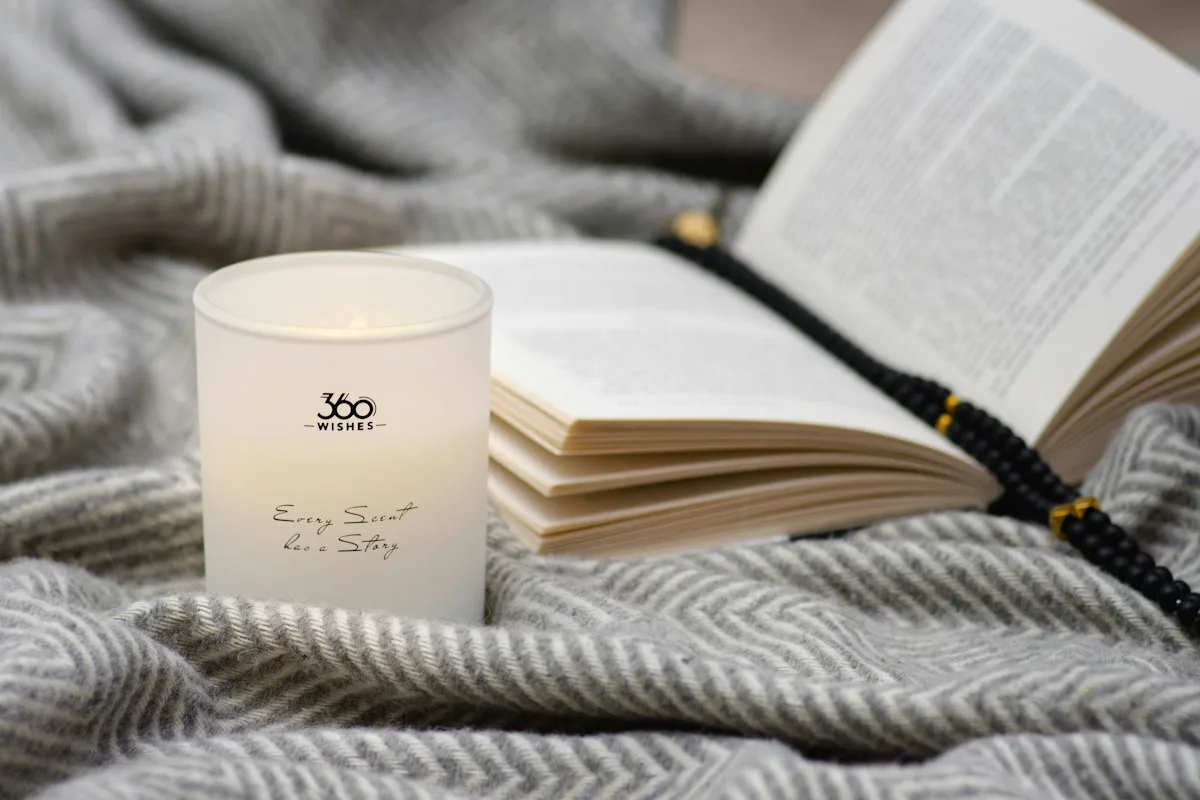 Open book beside a lit candle