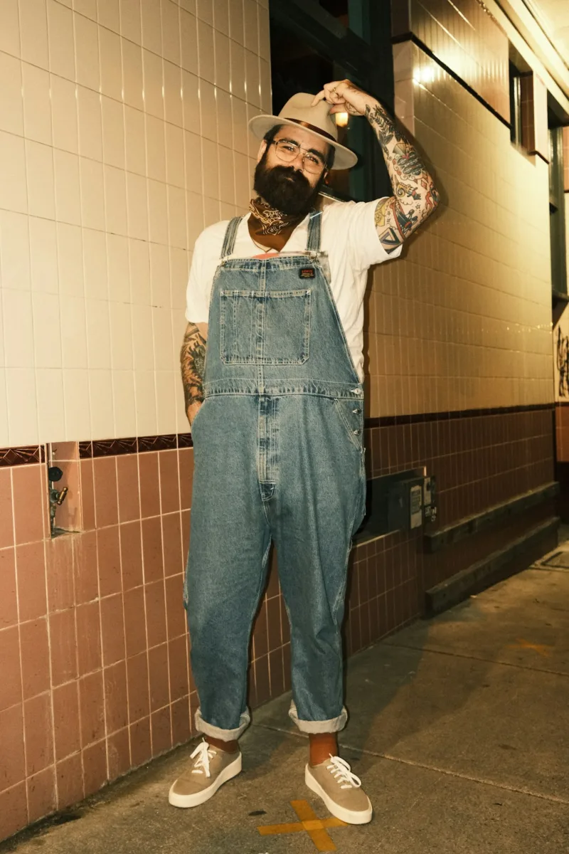 Person wearing blue denim overalls