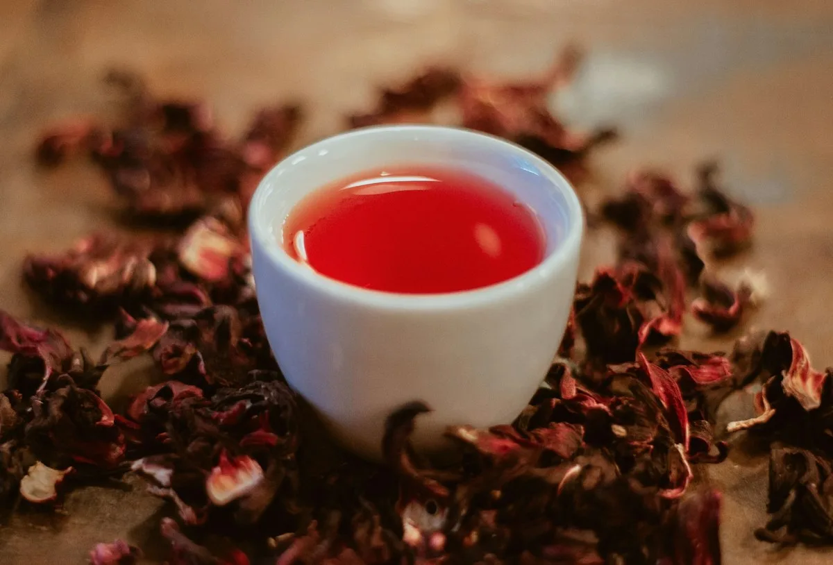 Red hibiscus tea in a white cup