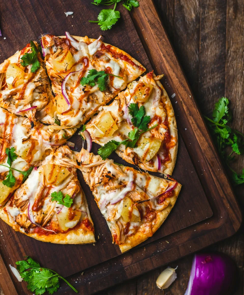 Sliced pizza on a wooden board
