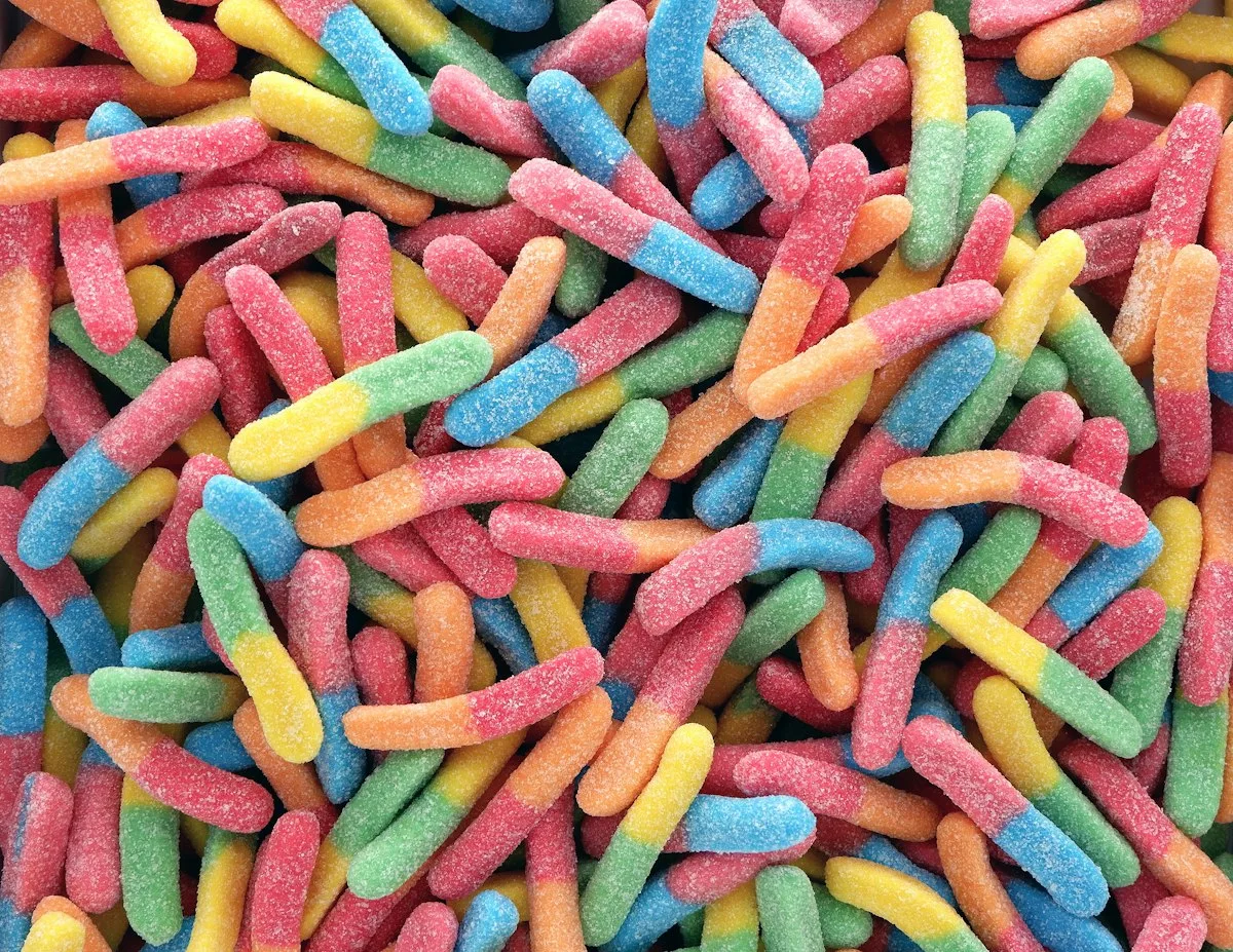 Sour gummy worms coated in sugar