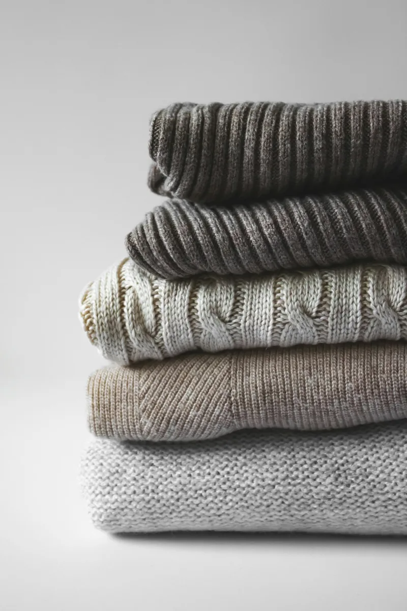 Stack of folded knit sweaters