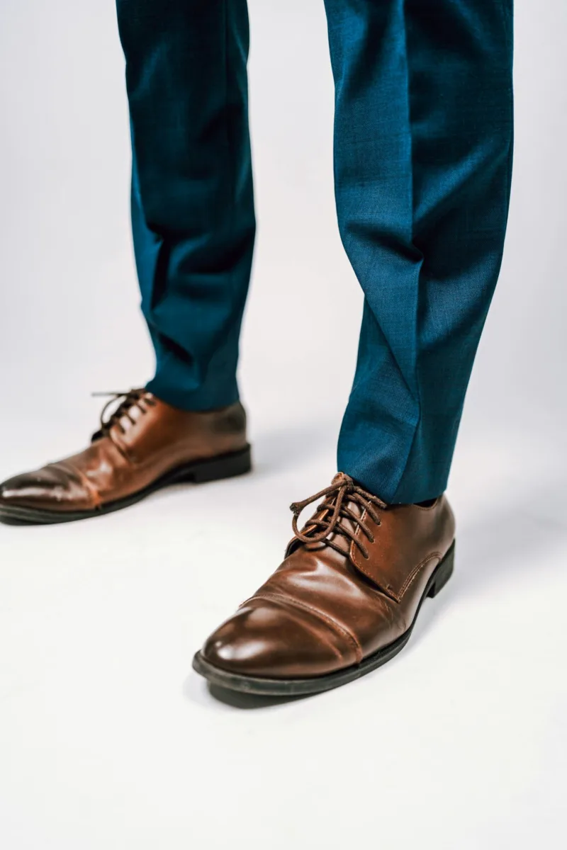 Tailored dress pants worn with leather shoes