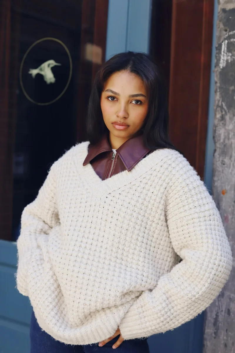 Woman wearing a cream V-neck sweater