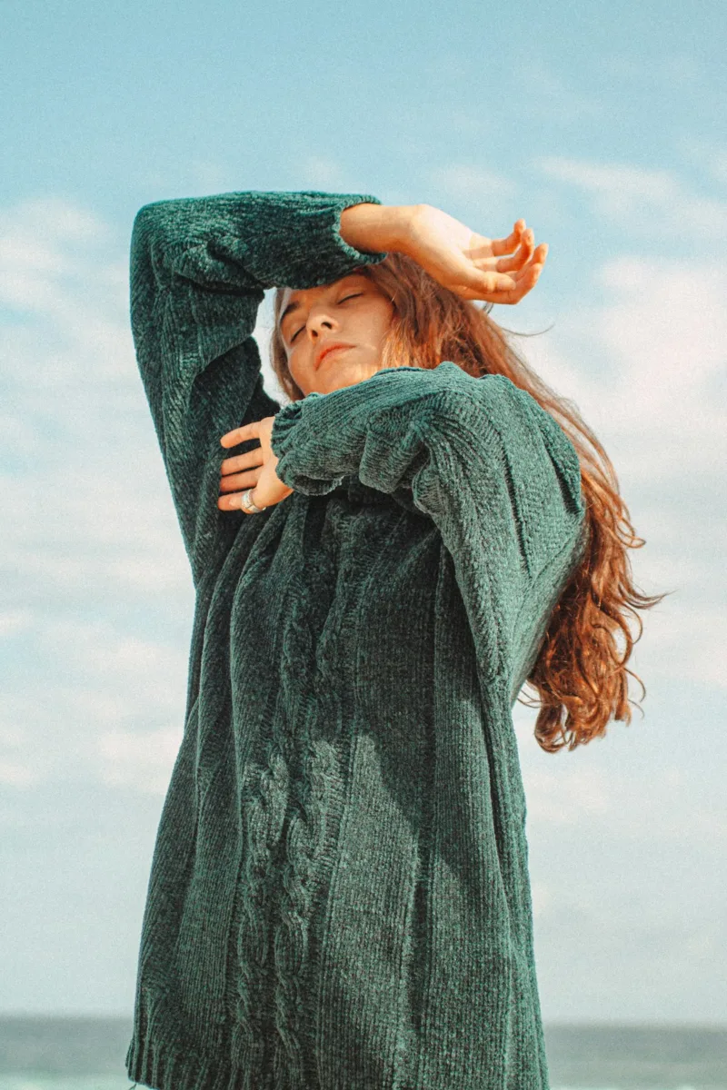 Woman wearing a green cable knit sweater