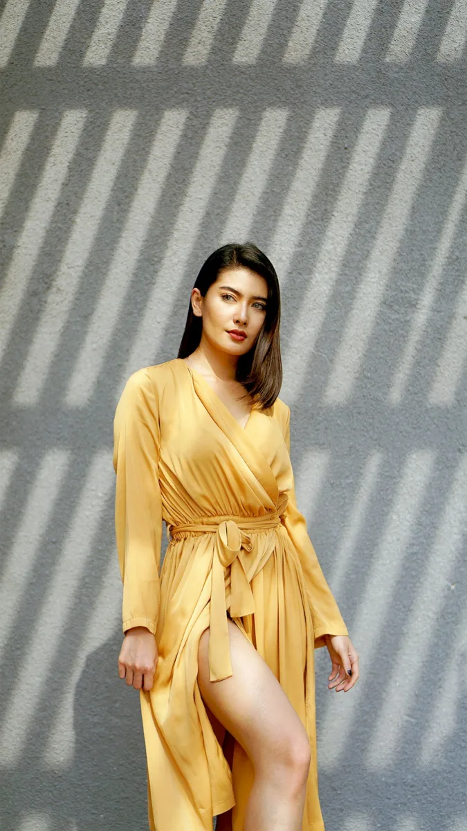 Woman wearing a yellow wrap dress
